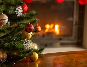 christmas tree in front of fireplace 